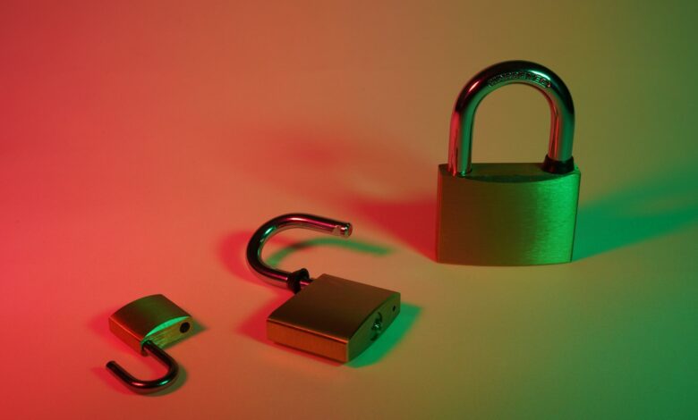 green and silver padlock on yellow surface