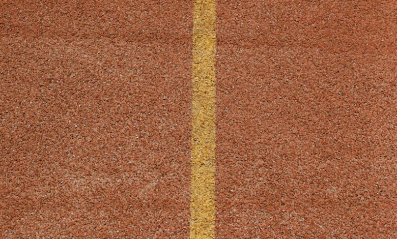 Vertical shot of a track with a yellow arrow indicating lane direction.