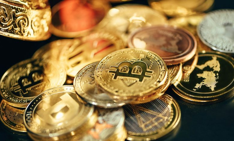 a pile of gold and silver coins sitting on top of a table