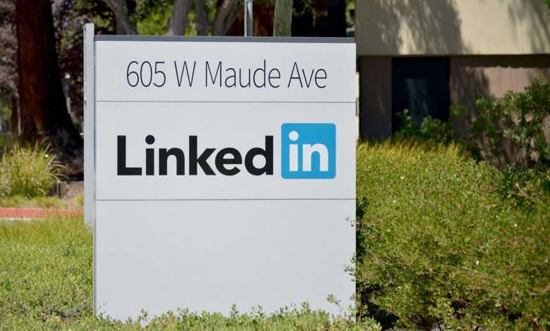 brown wooden signage on green grass field