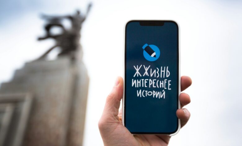 a person holding a cell phone in their hand