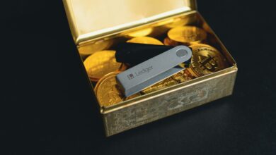 a swiss army knife sitting in a box of gold coins