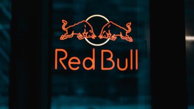 a red bull sign is lit up in the dark