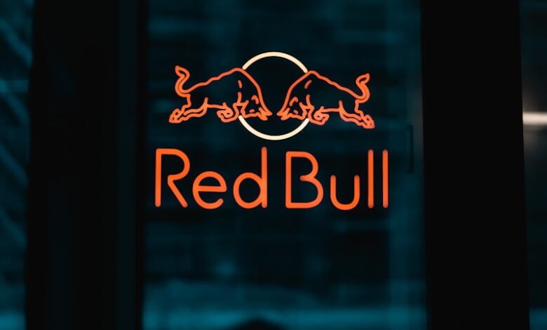 a red bull sign is lit up in the dark