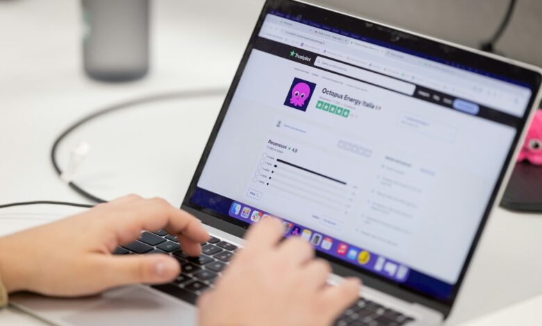 Person typing on a laptop computer screen.