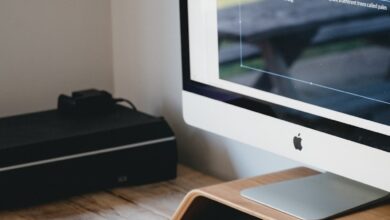 silver imac on brown wooden table