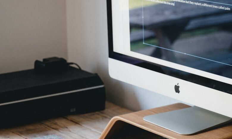 silver imac on brown wooden table