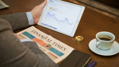 a person sitting at a table with a tablet and a cup of coffee