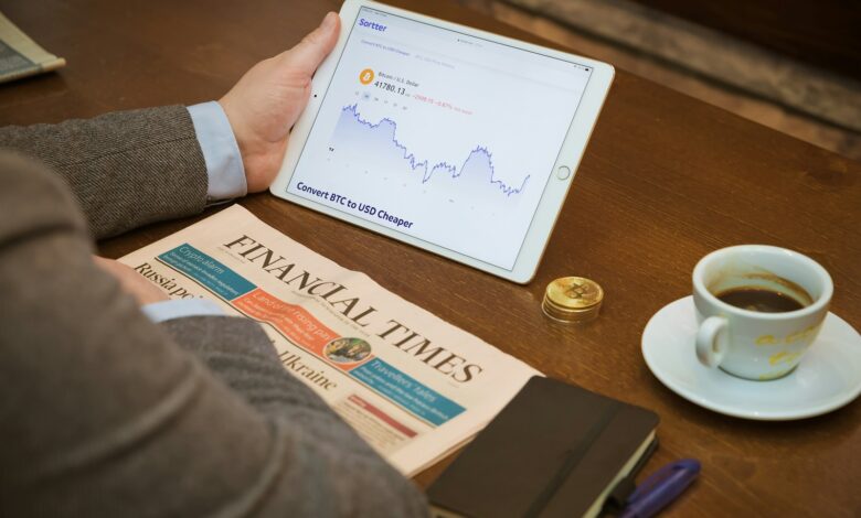 a person sitting at a table with a tablet and a cup of coffee