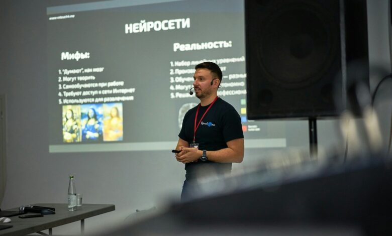 A man standing in front of a projector screen